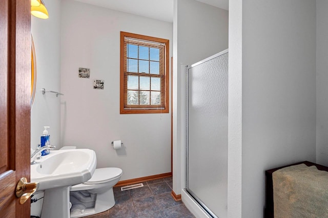 N2281 Lakewood Ln, Chilton, WI 53014 - full bathroom featuring a stall shower, toilet, and baseboards
