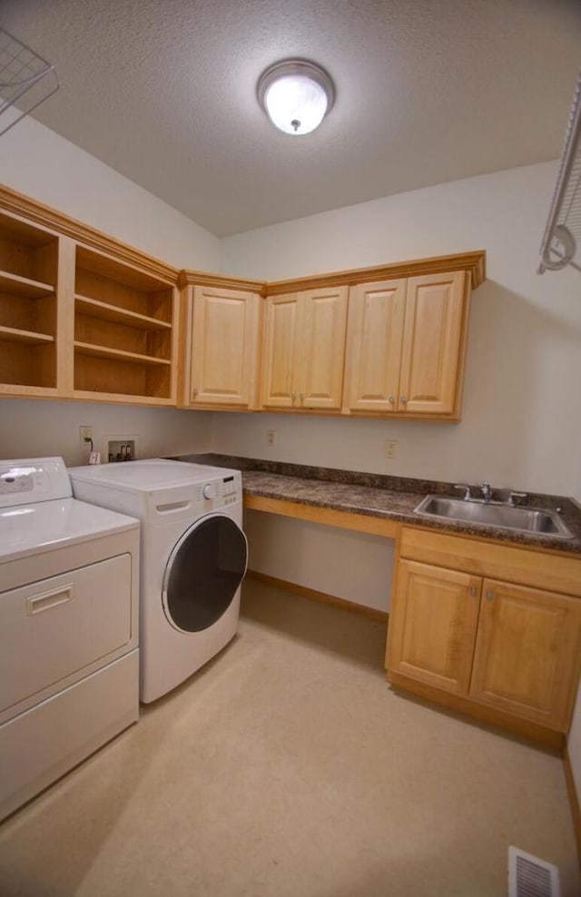 1835 Alpine Pl, Onalaska, WI 54650 - washroom with washing machine and dryer, cabinet space, light colored carpet, and a textured ceiling