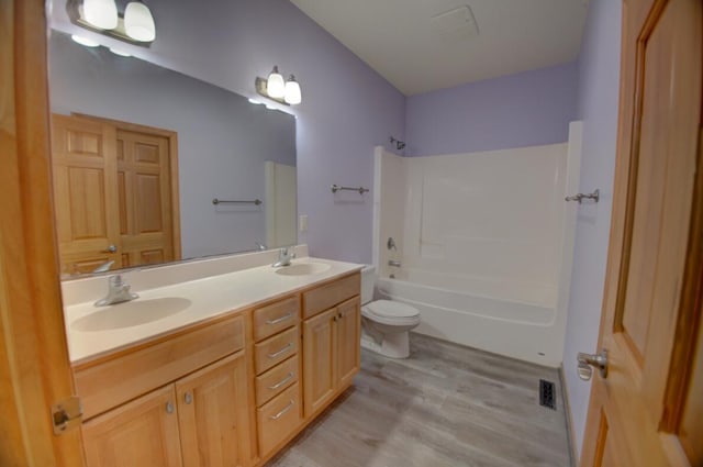 1835 Alpine Pl, Onalaska, WI 54650 - full bath with toilet, double vanity, wood finished floors, and bathtub / shower combination