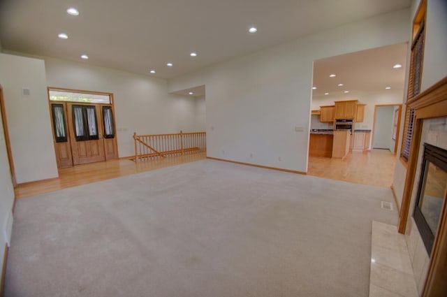 1835 Alpine Pl, Onalaska, WI 54650 - unfurnished living room with recessed lighting, light carpet, a fireplace, and baseboards