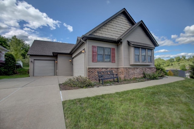 1835 Alpine Pl, Onalaska, WI 54650 - craftsman house with concrete driveway, an attached garage, brick siding, and a front lawn