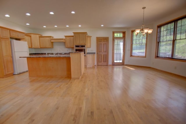 1835 Alpine Pl, Onalaska, WI 54650 - kitchen with freestanding refrigerator, oven, a chandelier, light wood-style flooring, and recessed lighting
