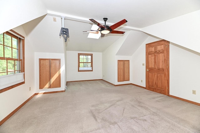 10906 W Wells St, Wauwatosa, WI 53226 - additional living space with ceiling fan, light colored carpet, lofted ceiling, and baseboards