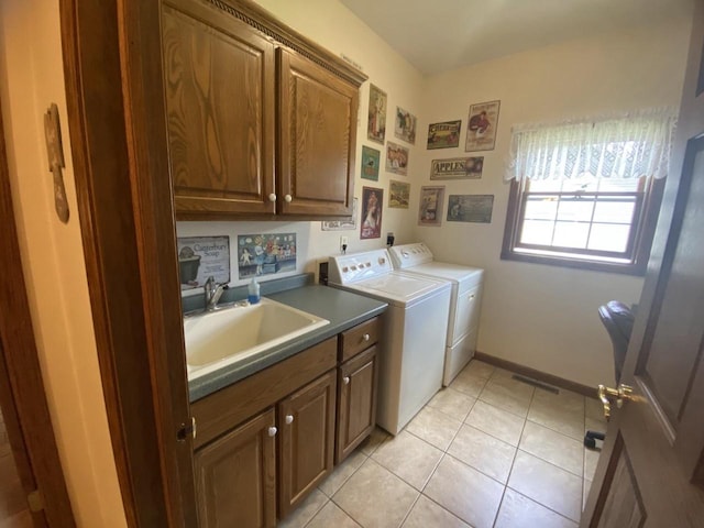 1430 Sherwood Ct, Wisconsin Rapids, WI 54494 - laundry room with cabinet space, washing machine and clothes dryer, light tile patterned flooring, and baseboards