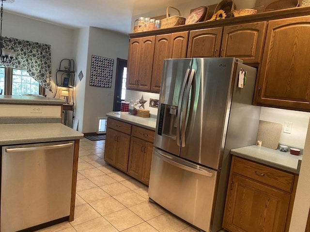 1430 Sherwood Ct, Wisconsin Rapids, WI 54494 - kitchen featuring stainless steel appliances, light tile patterned floors, light countertops, and a chandelier