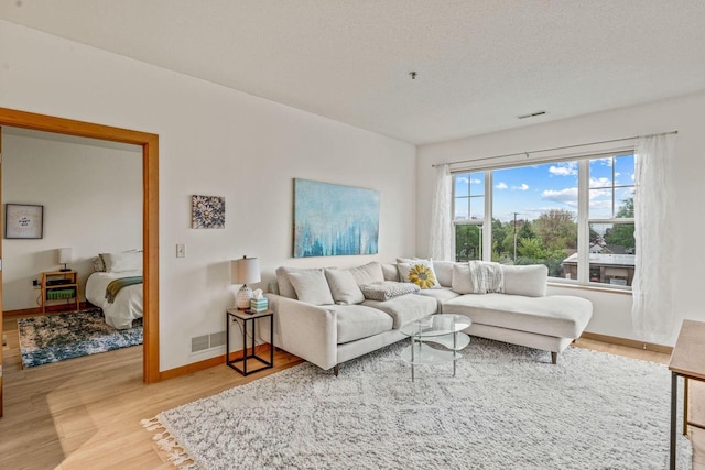 10900 W Bluemound Rd Unit 310, Wauwatosa, WI 53226 - living room featuring wood finished floors, baseboards, and a textured ceiling