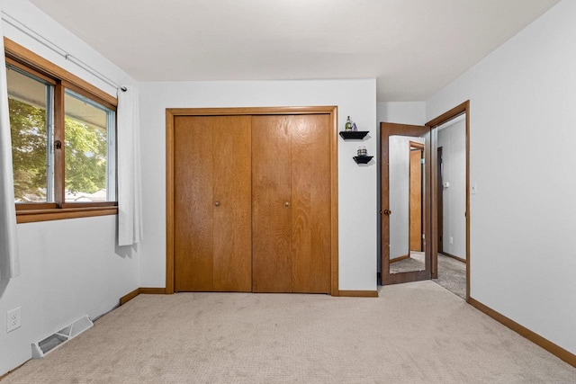 1037 S Union St, Shawano, WI 54166 - unfurnished bedroom featuring light colored carpet, a closet, and baseboards