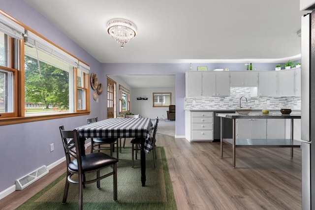 1037 S Union St, Shawano, WI 54166 - dining space featuring dark wood finished floors, a chandelier, and baseboards