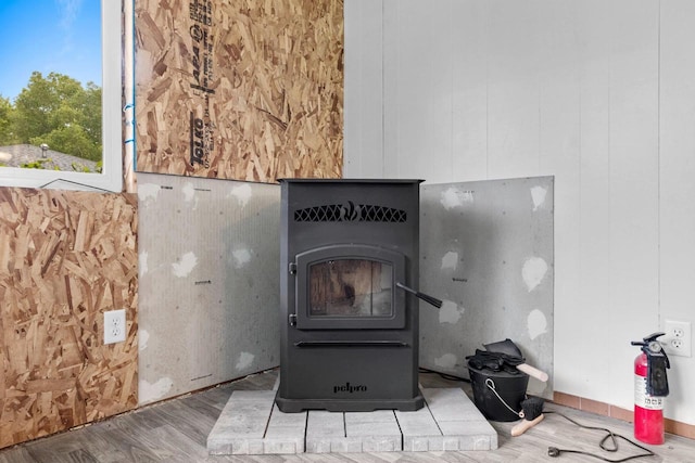 1037 S Union St, Shawano, WI 54166 - detailed view of a fire extinguisher, wood finished floors, and a wood stove