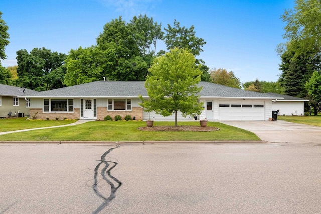 1037 S Union St, Shawano, WI 54166 - single story home featuring driveway, an attached garage, a front yard, brick siding, and central AC unit