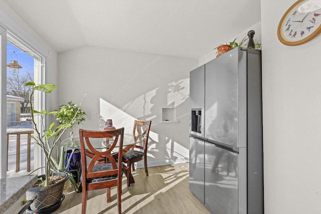 8721 W Douglas Ave, Milwaukee, WI 53225 - kitchen with stainless steel fridge with ice dispenser, light wood-style floors, vaulted ceiling, and baseboards