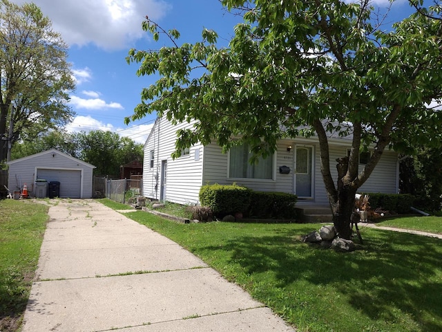 8721 W Douglas Ave, Milwaukee, WI 53225 - view of front of property featuring driveway, a detached garage, and an outbuilding