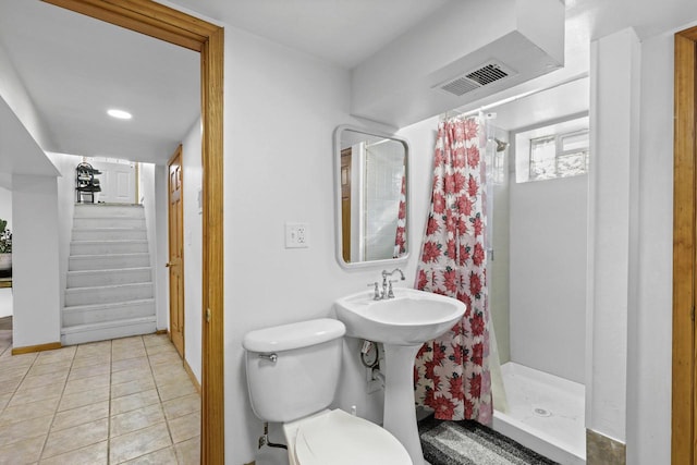 8721 W Douglas Ave, Milwaukee, WI 53225 - full bath featuring a shower stall, toilet, tile patterned flooring, and baseboards