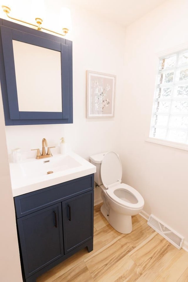 9533 W Silver Spring Dr, Milwaukee, WI 53225 - bathroom featuring vanity, toilet, baseboards, and wood finished floors