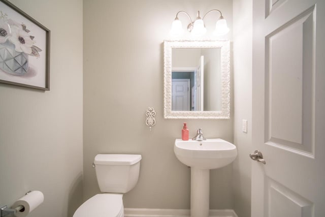 739 Shore Ln, West Bend, WI 53090 - bathroom featuring toilet and baseboards