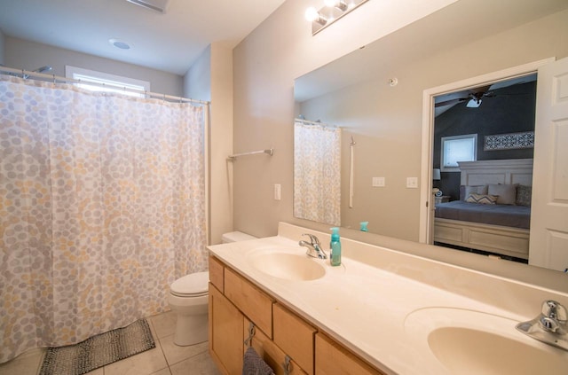 739 Shore Ln, West Bend, WI 53090 - ensuite bathroom featuring tile patterned flooring, double vanity, toilet, ceiling fan, and a shower with shower curtain