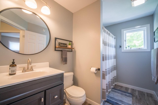 739 Shore Ln, West Bend, WI 53090 - full bathroom featuring wood finished floors, toilet, vanity, baseboards, and a shower with curtain