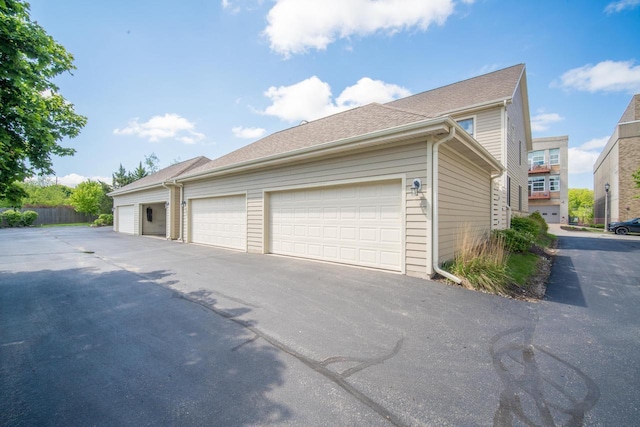 739 Shore Ln, West Bend, WI 53090 - view of home's exterior featuring community garages