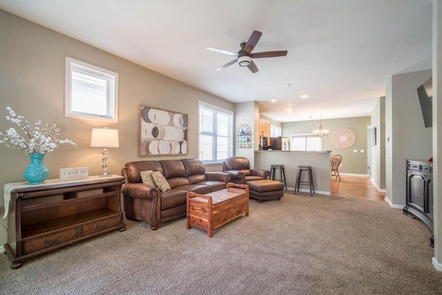 739 Shore Ln, West Bend, WI 53090 - living room with carpet floors, a chandelier, a ceiling fan, and baseboards