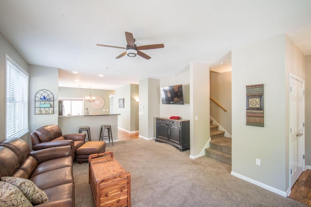 739 Shore Ln, West Bend, WI 53090 - living area with ceiling fan, a chandelier, stairway, carpet, and baseboards