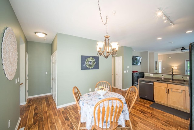 739 Shore Ln, West Bend, WI 53090 - dining space with dark wood-style flooring, a chandelier, baseboards, and track lighting