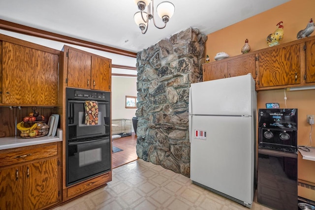 1104 Cavalier Dr, Waukesha, WI 53186 - kitchen with freestanding refrigerator, light floors, brown cabinets, light countertops, and a chandelier