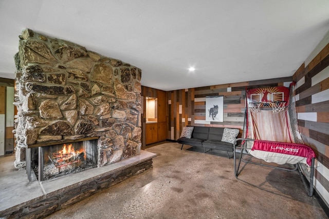 1104 Cavalier Dr, Waukesha, WI 53186 - living room with wood walls, a fireplace, and concrete floors