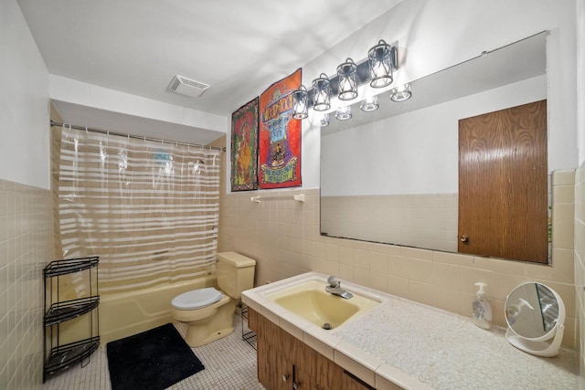 1104 Cavalier Dr, Waukesha, WI 53186 - full bathroom featuring tile walls, vanity, shower / bathtub combination with curtain, toilet, and tile patterned flooring