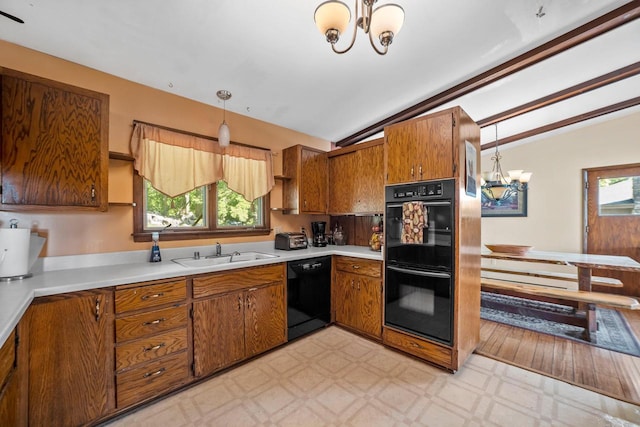 1104 Cavalier Dr, Waukesha, WI 53186 - kitchen with black appliances, a chandelier, a sink, lofted ceiling, and brown cabinets