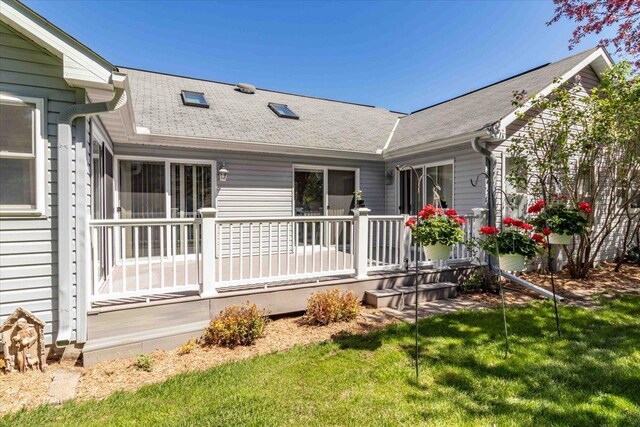 3810 Timber Valley Dr, Wisconsin Rapids, WI 54494 - back of property featuring a wooden deck, a shingled roof, and a yard