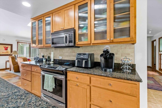 3810 Timber Valley Dr, Wisconsin Rapids, WI 54494 - kitchen with stainless steel appliances, tasteful backsplash, dark stone countertops, glass insert cabinets, and recessed lighting