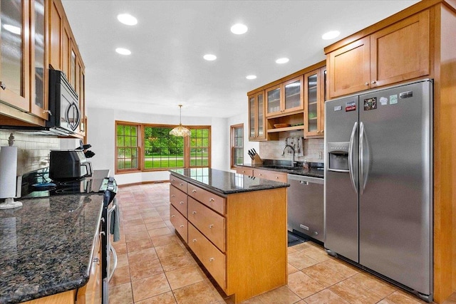 3810 Timber Valley Dr, Wisconsin Rapids, WI 54494 - kitchen featuring appliances with stainless steel finishes, a center island, brown cabinetry, recessed lighting, and backsplash