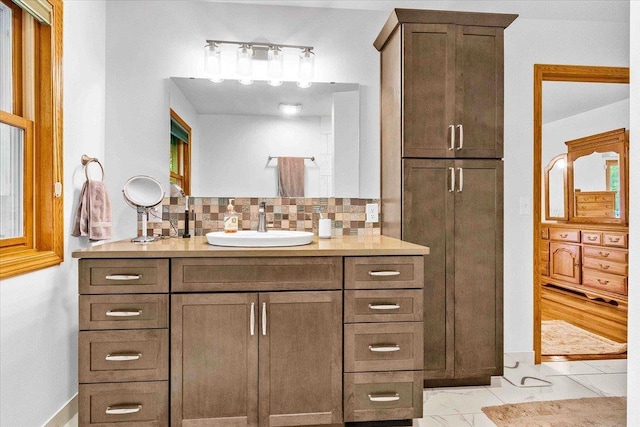 3810 Timber Valley Dr, Wisconsin Rapids, WI 54494 - bathroom featuring vanity, tasteful backsplash, and marble look tiles