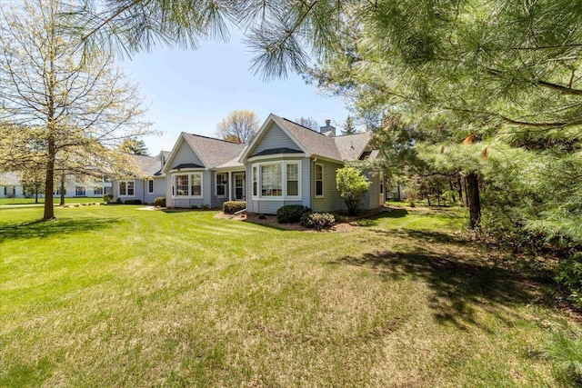 3810 Timber Valley Dr, Wisconsin Rapids, WI 54494 - view of front of home with a front yard and a chimney