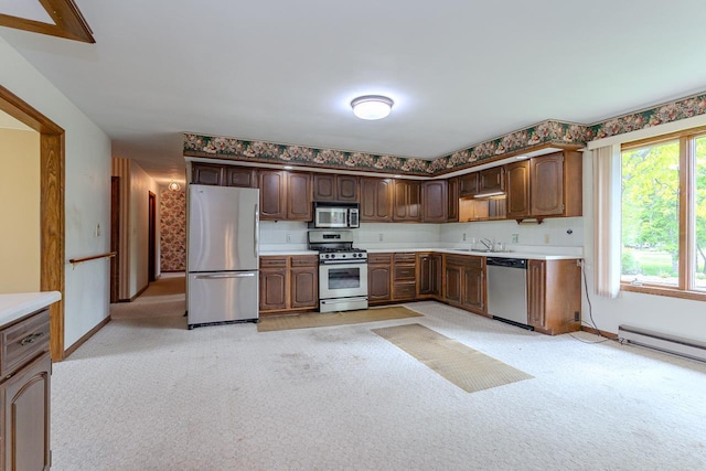 419 E Beech St, Edgar, WI 54426 - kitchen with stainless steel appliances, light carpet, light countertops, and baseboards