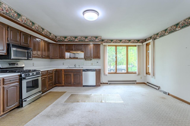 419 E Beech St, Edgar, WI 54426 - kitchen featuring stainless steel appliances, baseboard heating, a sink, light countertops, and light carpet