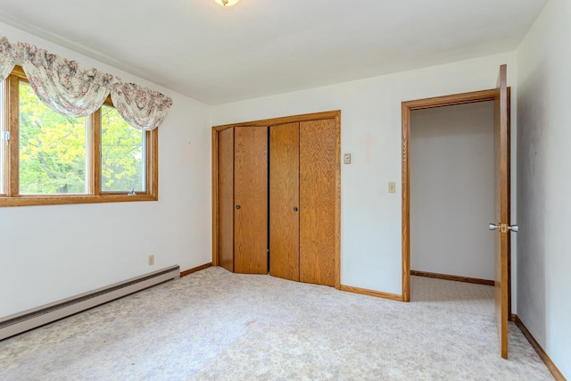 419 E Beech St, Edgar, WI 54426 - unfurnished bedroom with baseboard heating, a closet, carpet floors, and baseboards