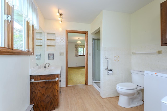 419 E Beech St, Edgar, WI 54426 - bathroom with tile walls, vanity, toilet, wood finished floors, and a shower with shower door