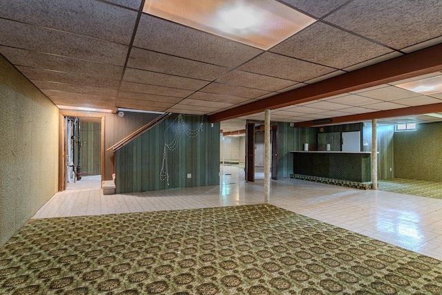 419 E Beech St, Edgar, WI 54426 - finished basement with tile patterned floors, a paneled ceiling, a textured wall, and bar