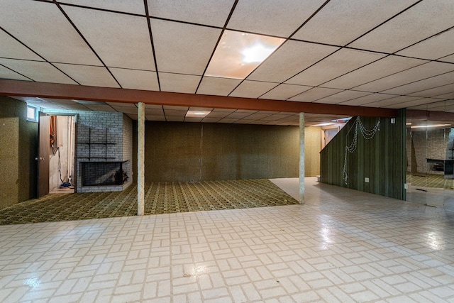 419 E Beech St, Edgar, WI 54426 - finished basement featuring a brick fireplace, brick patterned flooring, and a paneled ceiling