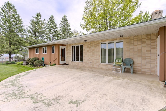 419 E Beech St, Edgar, WI 54426 - rear view of house with a chimney, a patio, and brick siding