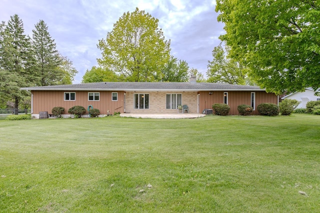 419 E Beech St, Edgar, WI 54426 - view of front facade featuring a patio, a chimney, a front lawn, and board and batten siding