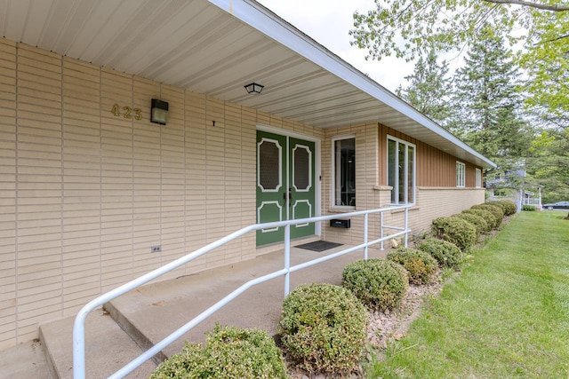 419 E Beech St, Edgar, WI 54426 - view of exterior entry with brick siding and a yard