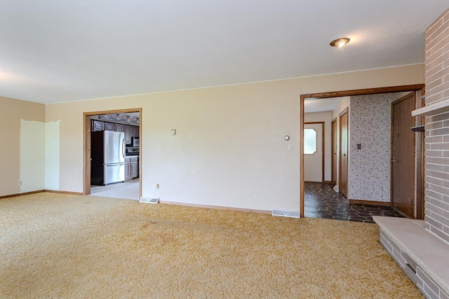 419 E Beech St, Edgar, WI 54426 - carpeted spare room featuring baseboards and a brick fireplace