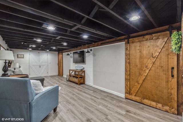 2590 S 91st St, West Allis, WI 53227 - living room with a barn door, wood finished floors, and baseboards