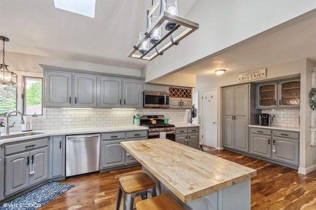 2590 S 91st St, West Allis, WI 53227 - kitchen featuring stainless steel appliances, gray cabinetry, a sink, and butcher block counters