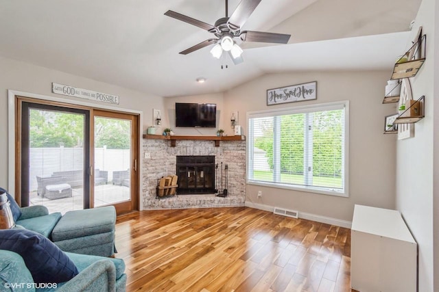 2590 S 91st St, West Allis, WI 53227 - living area featuring a ceiling fan, lofted ceiling, wood finished floors, a brick fireplace, and baseboards