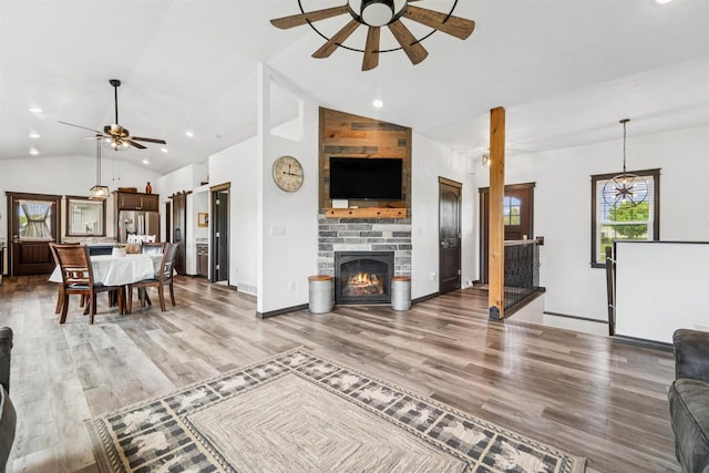 3815 Stone Wall Dr, De Pere, WI 54115 - living room featuring a ceiling fan, vaulted ceiling, light wood finished floors, a fireplace, and recessed lighting