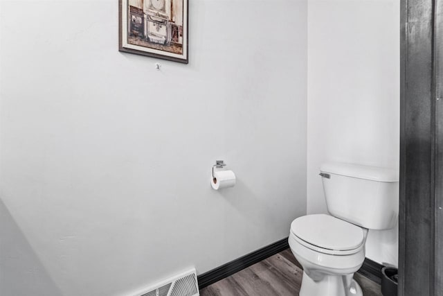 3815 Stone Wall Dr, De Pere, WI 54115 - bathroom featuring toilet, baseboards, and wood finished floors
