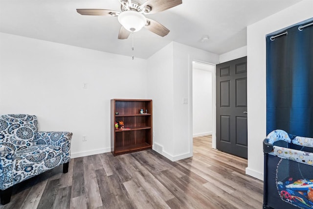 3815 Stone Wall Dr, De Pere, WI 54115 - sitting room with wood finished floors, a ceiling fan, and baseboards